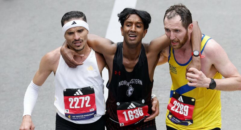 Moment two Boston Marathon runners stop to help exhausted rival finish