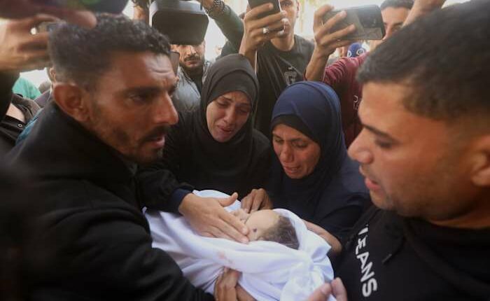 Palestinians hold funerals for pregnant woman and her children killed in Israeli strikes