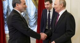 Putin puts on huge smile as he greets Iran's foreign minister â and vows to 'serve' Tehran's interests