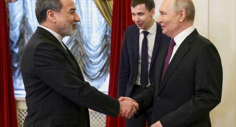 Putin puts on huge smile as he greets Iran's foreign minister â and vows to 'serve' Tehran's interests