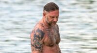 Shirtless Tom Hardy displays his vast collection of tattoos