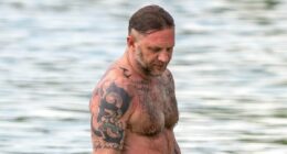 Shirtless Tom Hardy displays his vast collection of tattoos