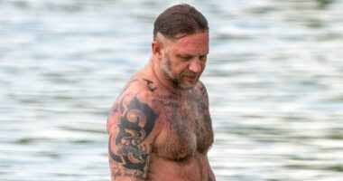 Shirtless Tom Hardy displays his vast collection of tattoos