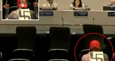 Swastika-wearing agitator makes profane gestures at LAPD officials