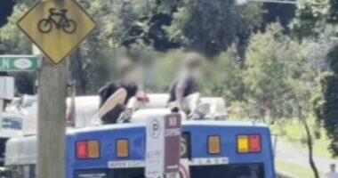 Teenagers who rode on bus roof sought by police