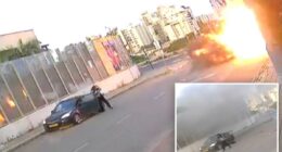 Video shows Israeli woman knocked to the ground as missile explodes next to her -- before getting up and walking away