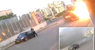 Video shows Israeli woman knocked to the ground as missile explodes next to her -- before getting up and walking away