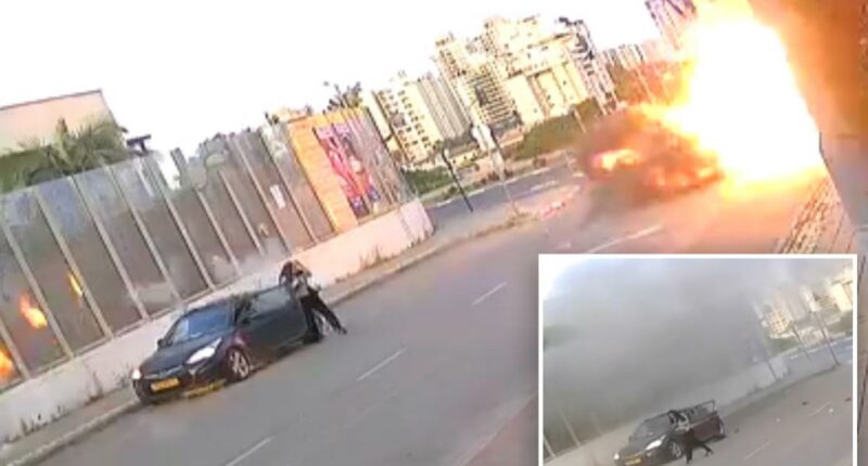 Video shows Israeli woman knocked to the ground as missile explodes next to her -- before getting up and walking away
