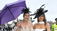 We're singin' in the rain! Aintree revellers dodge the drops in skirts