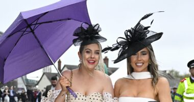 We're singin' in the rain! Aintree revellers dodge the drops in skirts