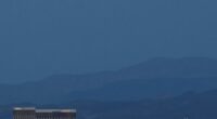 LAS VEGAS, NEVADA - APRIL 07:  The super pink moon, the biggest supermoon of the year, rises over (L-R) Delano Las Vegas at Mandalay Bay Resort and Casino, Mandalay Bay Resort and Casino, the under construction Allegiant Stadium and McCarran International Airport on April 7, 2020 in Las Vegas, Nevada. The pink moon got its name because the April full moon occurs at the same time as the pink wildflower Phlox subulata blooms in North America. A supermoon occurs when a full moon coincides with its