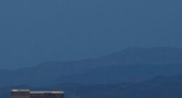LAS VEGAS, NEVADA - APRIL 07:  The super pink moon, the biggest supermoon of the year, rises over (L-R) Delano Las Vegas at Mandalay Bay Resort and Casino, Mandalay Bay Resort and Casino, the under construction Allegiant Stadium and McCarran International Airport on April 7, 2020 in Las Vegas, Nevada. The pink moon got its name because the April full moon occurs at the same time as the pink wildflower Phlox subulata blooms in North America. A supermoon occurs when a full moon coincides with its