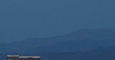 LAS VEGAS, NEVADA - APRIL 07:  The super pink moon, the biggest supermoon of the year, rises over (L-R) Delano Las Vegas at Mandalay Bay Resort and Casino, Mandalay Bay Resort and Casino, the under construction Allegiant Stadium and McCarran International Airport on April 7, 2020 in Las Vegas, Nevada. The pink moon got its name because the April full moon occurs at the same time as the pink wildflower Phlox subulata blooms in North America. A supermoon occurs when a full moon coincides with its