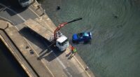Car being pulled from the water.
