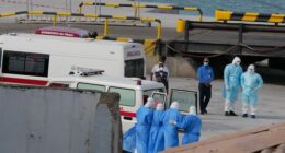 Health workers in protective gear evacuate patients from the MV Hondius cruise ship at a port in Praia, Cape Verde, Wednesday, May 6, 2026. (AP Photo/Misper Apawu)