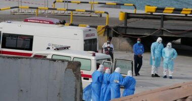 Health workers in protective gear evacuate patients from the MV Hondius cruise ship at a port in Praia, Cape Verde, Wednesday, May 6, 2026. (AP Photo/Misper Apawu)