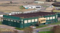 Controversial former RAF base earmarked for 2,000 asylum seekers finds ground gases and unexploded artillery on the land, minister claims