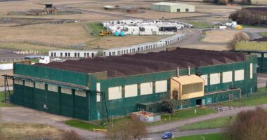 Controversial former RAF base earmarked for 2,000 asylum seekers finds ground gases and unexploded artillery on the land, minister claims