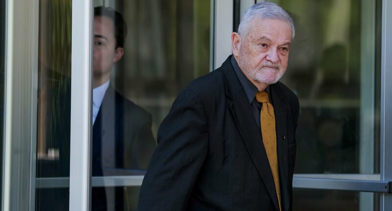 Dr Fauci's top aide's face says it all as he's booked in court on federal charges for 'COVID cover up'