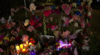 A large floral tribute has grown in the town with bouquets of flowers, candles and soft toys.