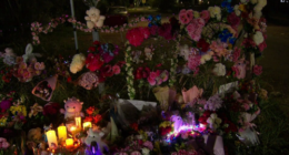 A large floral tribute has grown in the town with bouquets of flowers, candles and soft toys.