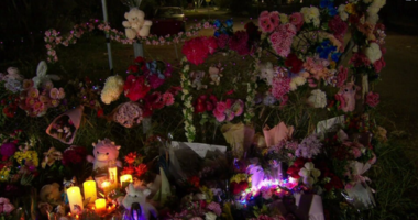 A large floral tribute has grown in the town with bouquets of flowers, candles and soft toys.