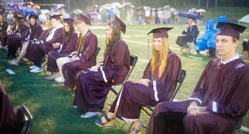 High school faces backlash as graduation held in torrential downpour