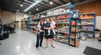 The Kozma family pose together inside one of the Waves Never Die warehouses.