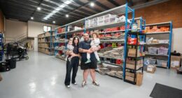 The Kozma family pose together inside one of the Waves Never Die warehouses.