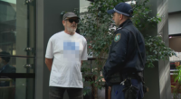 A man has been given move-on orders by police after wearing a shirt bearing a swastika outside the building in which the royal commission is being held.