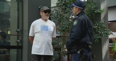 A man has been given move-on orders by police after wearing a shirt bearing a swastika outside the building in which the royal commission is being held.