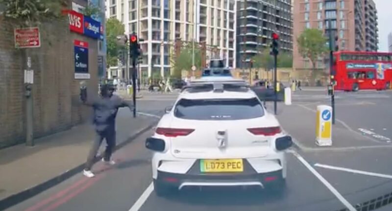 Moment man hurls rock at Waymo- before 'driverless car' runs red light