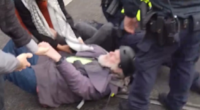 An elderly protester has been pushed to the ground as tensions flared at a disability funding rally in Melbourne.