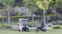 Teens riding on motorized bikes through a golf course in Florida.