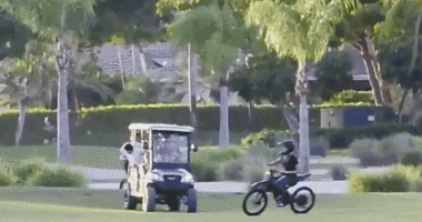 Teens riding on motorized bikes through a golf course in Florida.
