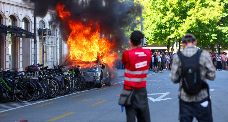 Anti-G7 protest turns violent as demonstrators torch Tesla and smash UN office windows
