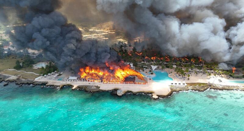 At least one dead and 1,700 evacuated after fire at beach resort