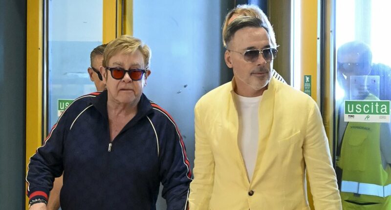 Elton John is frisked by Italian police at the airport