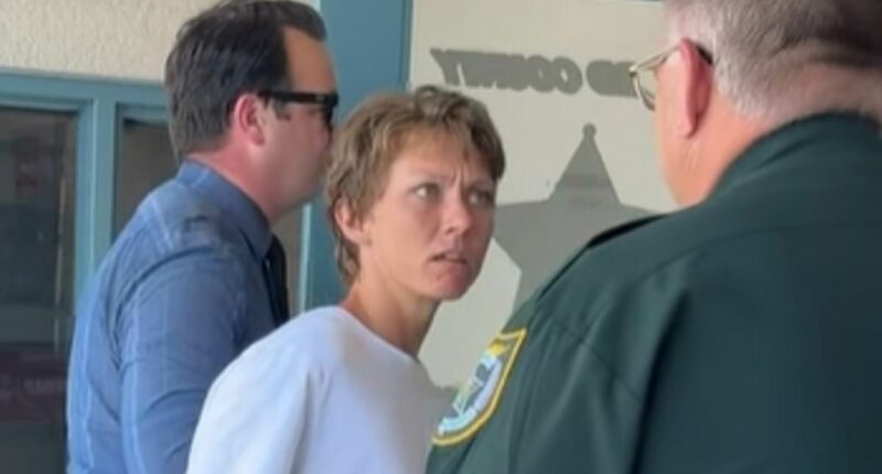Female owner of killer pit bulls loses power of speech during arrest