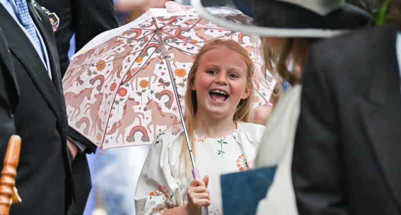 No raining on her parade! Cheeky Lena Tindall, seven, entertains herself with a unicorn umbrella at Peter Phillips's wedding - while sister Mia, 12, shows off her sense of style in metallic heels