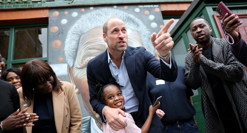 Prince of hugs! William embraces a young fan during surprise visit to a Peckham pub