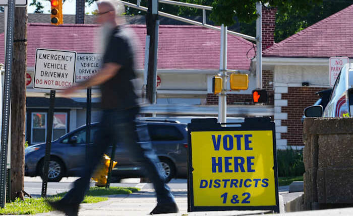 The Latest: Polls open for races across the US as a busy primary election day gets underway