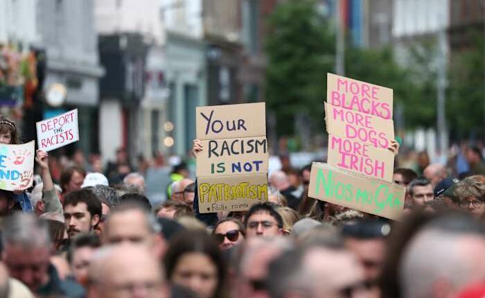 Thousands rally in Belfast to condemn anti-immigrant rioting that followed stabbing