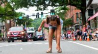 Nova Winchester, 7, of Putney, Vt., races out to collect candy during the Fourth of July parade in Brattleboro, Vt., on Saturday, July 4, 2026. (Kristopher Radder/The Brattleboro Reformer via AP)