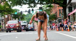 Nova Winchester, 7, of Putney, Vt., races out to collect candy during the Fourth of July parade in Brattleboro, Vt., on Saturday, July 4, 2026. (Kristopher Radder/The Brattleboro Reformer via AP)