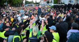 Tens of thousands of far-left protesters clash with police in anti-conservative party riots