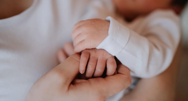 The measles outbreak is "slowing." A newborn's family still can't meet her.