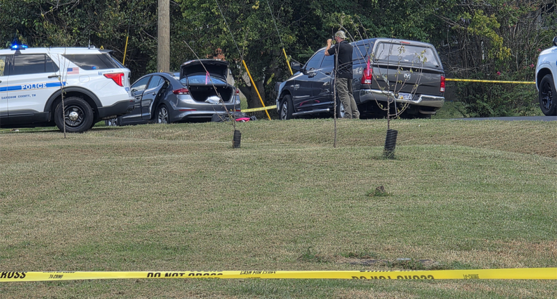Police fatally shoot sword-wielding man after woman found trapped in car, officials say