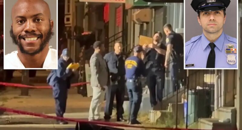 Accused Philadelphia cop killer grins as he's hit with 76 charges