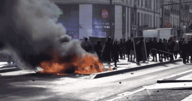 A gif of Protesters burned trash cans and plastic containers near a campus in the Paris